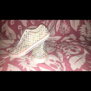 White converse with pastel glitter stars.